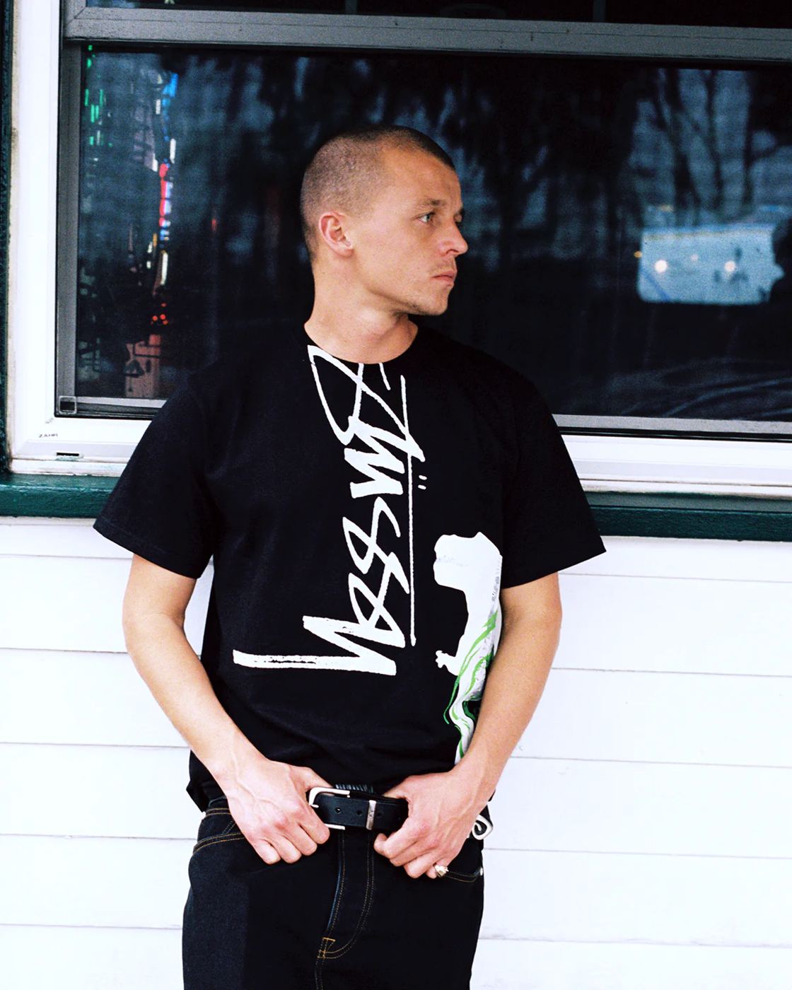 Black tee worn against a window